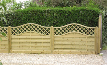A blonde wood timber fence with curved lattice top